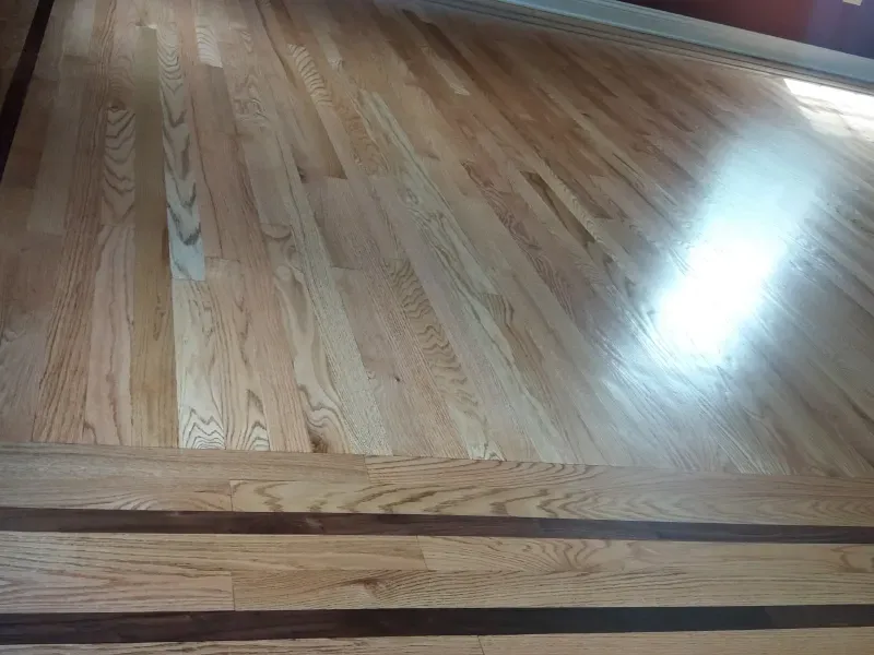 A close up of a wooden floor with a wooden border.