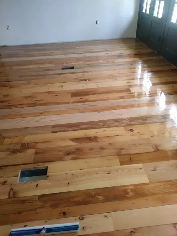 A living room with hardwood floors and a door.