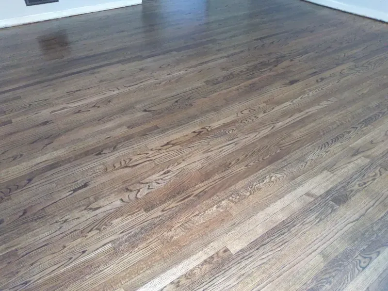 A close up of a wooden floor in a living room.